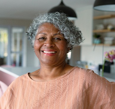Closeup of woman smiling in kitchen at home
