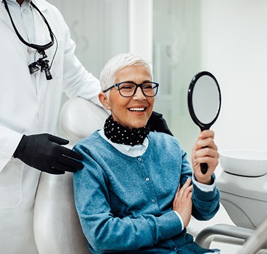 Senior woman smiling while looking at reflection