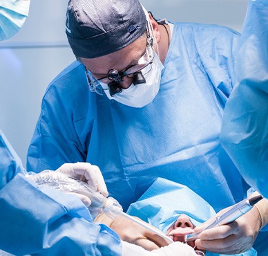Oral surgeons performing dental implant surgery