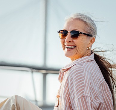 Senior woman smiling while relaxing on boat